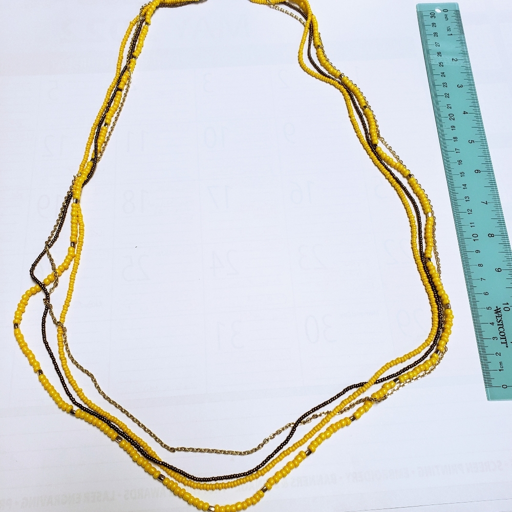 Loft long beaded necklace.  New wo tags.  Yellow, gold and bronze. 30 inches.